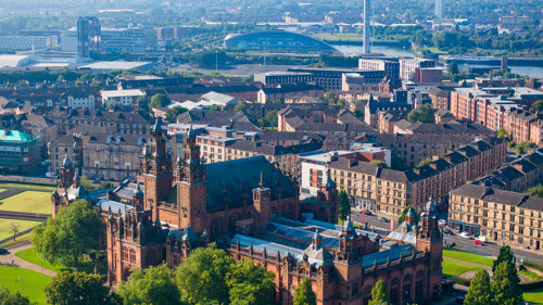 An aerial view of Kelvingrove Art Gallery and Museum and spanning across the west end of Glasgow and the River Clyde.